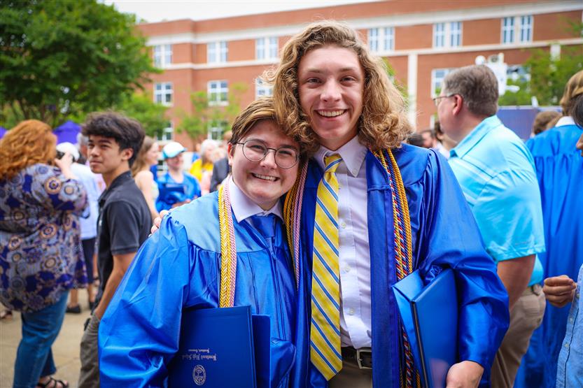A group of graduates wearing blue robes